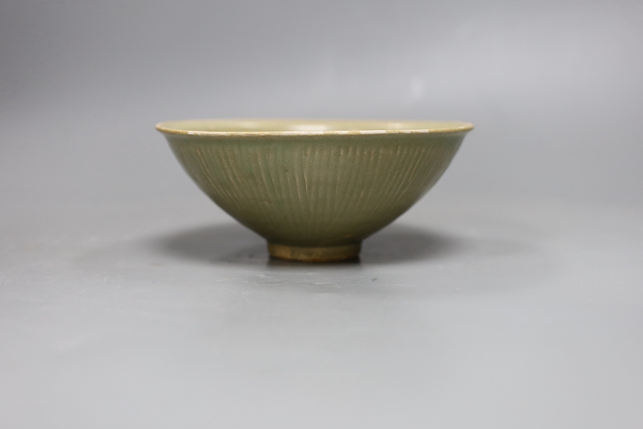 A Chinese carved Yaozhou celadon bowl, Northern Song Dynasty, 15.5cms high